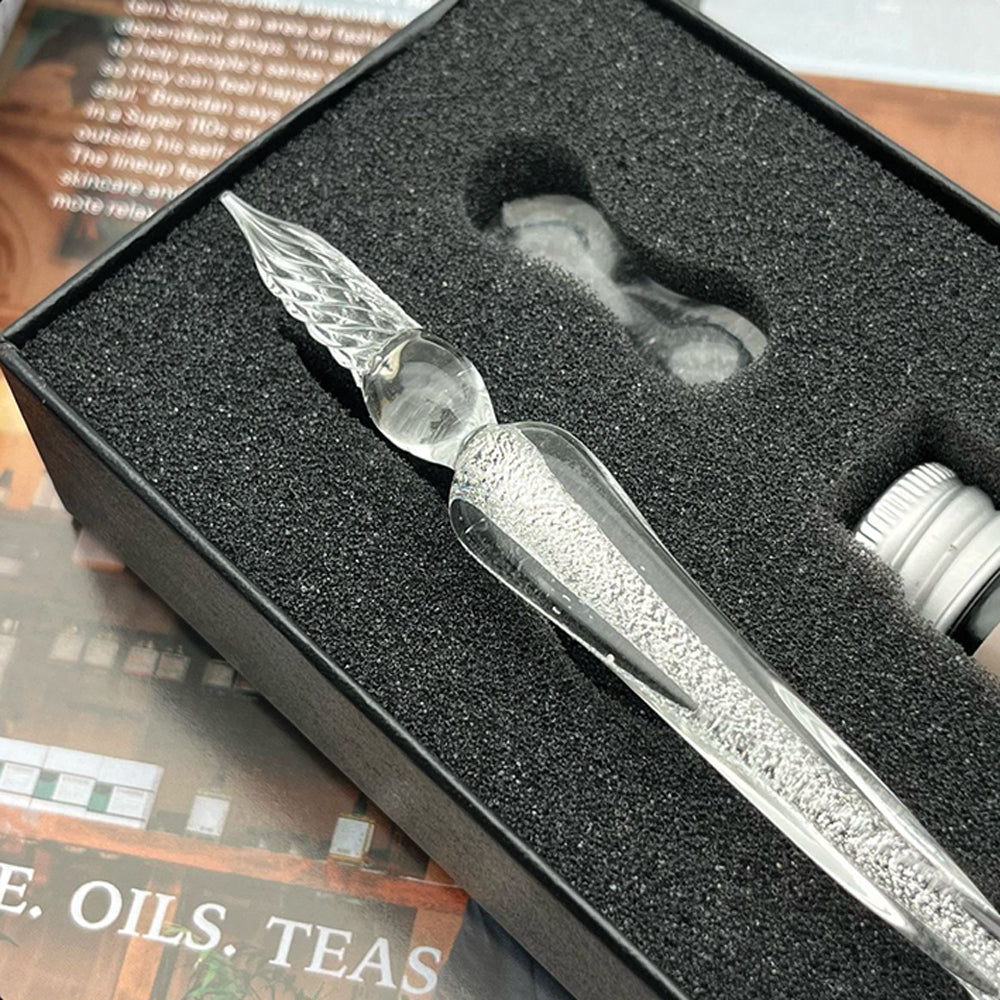 Decorative pen in a black box with a pen rest and ink