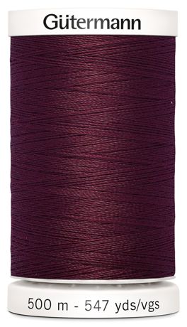 Spool of Gutermann thread in dark purple on a white background