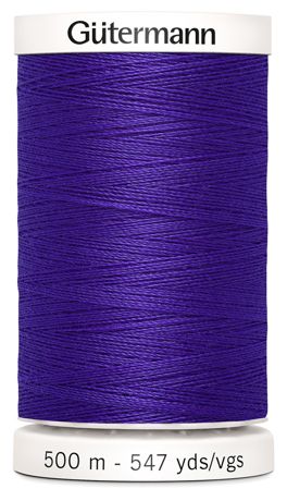 Spool of purple Gutermann thread on a white background
