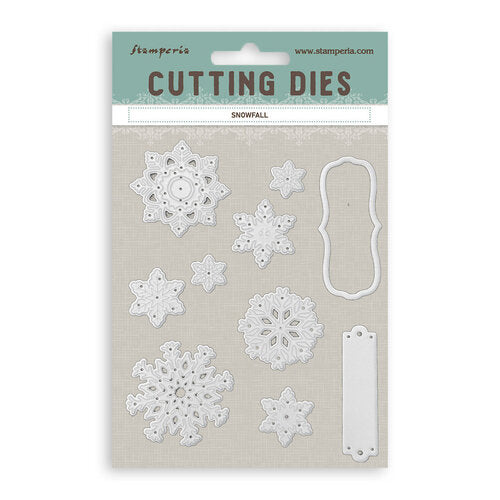 Stamperia Snowfall cutting dies set in its original packaging, featuring white metal dies for crafting snowflake and frame designs on a textured beige backing card.