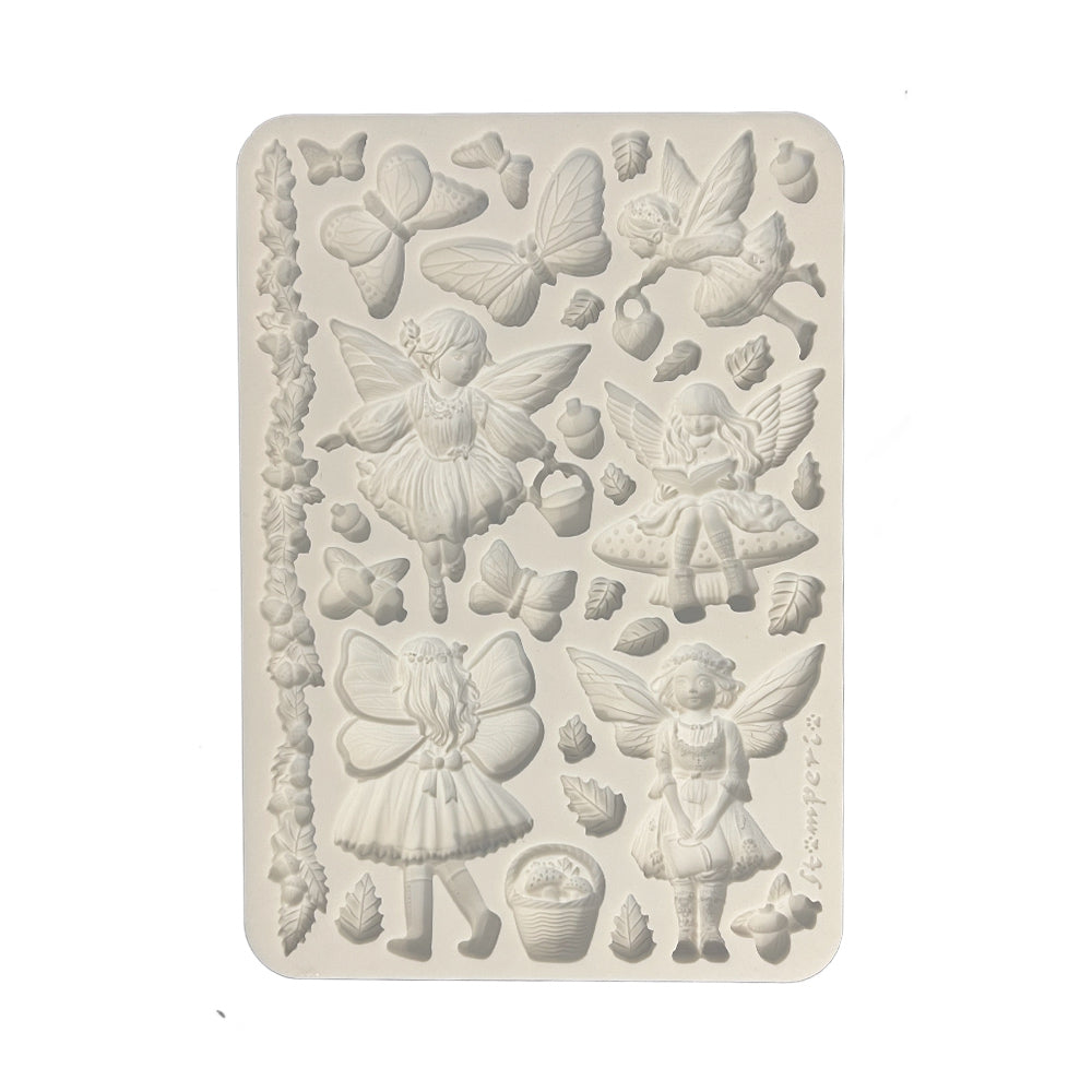 Decorative silicone mold with fairy and butterfly designs on a beige background