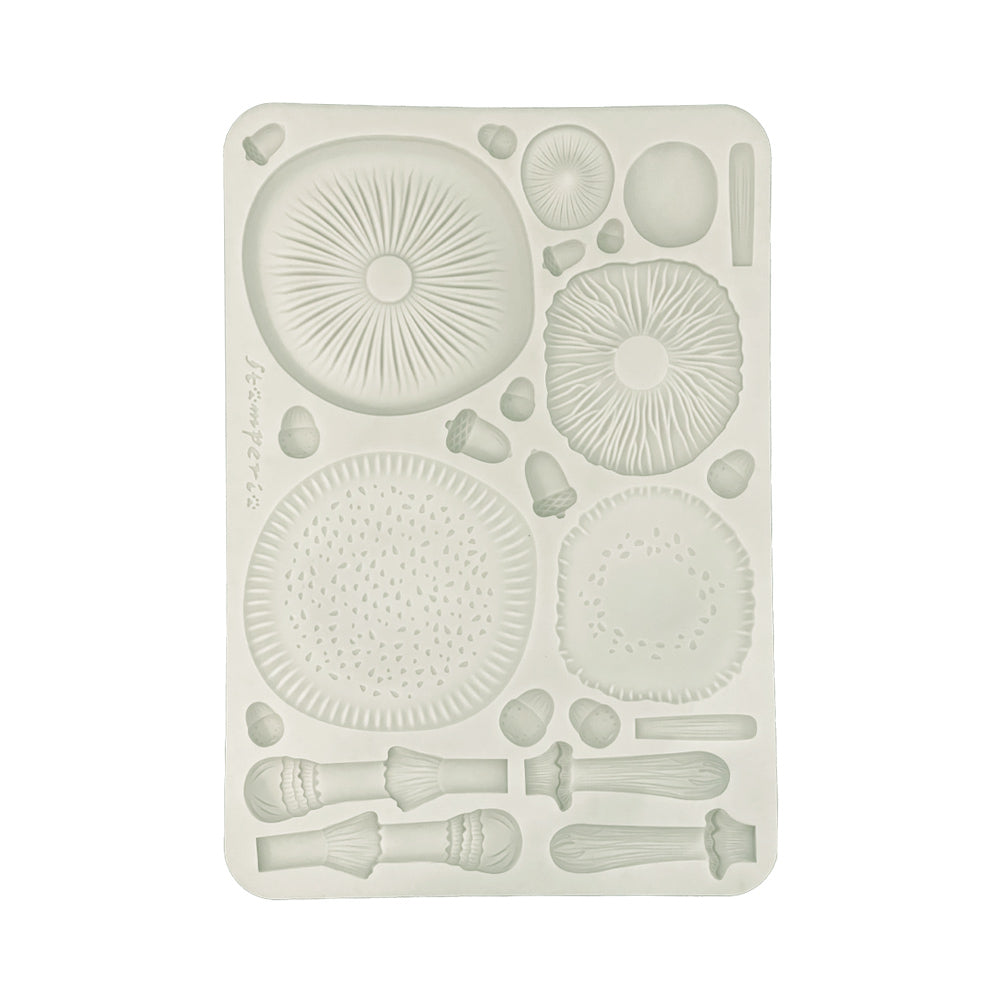 Silicone mold with mushroom and brush designs on a white background