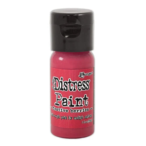 Red bottle of Ranger Distress Paint with black cap on a white background