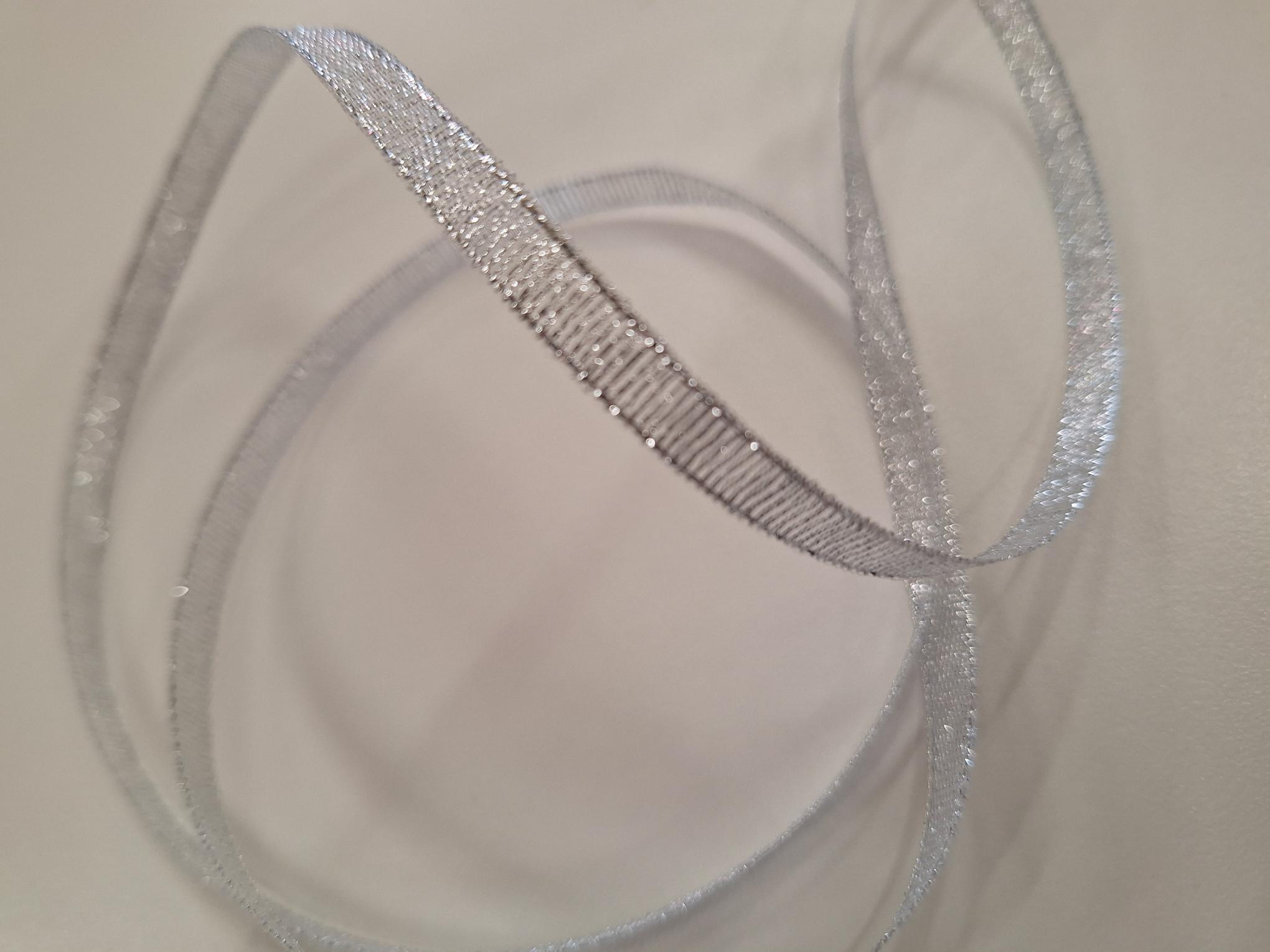 Silver metallic ribbon 6mm wide. Sold by the metre