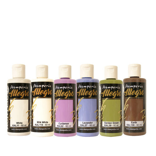 Set of five small bottles with colorful labels on a black background