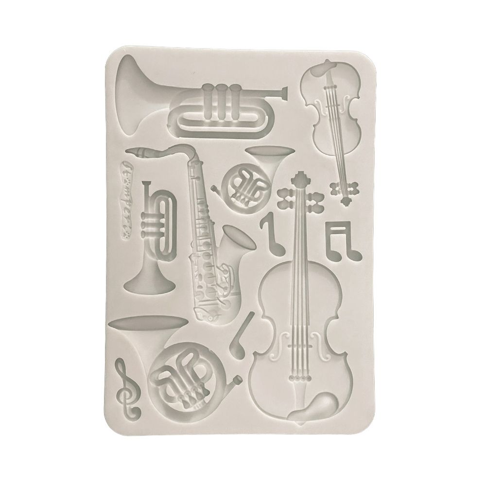 Silicone mold with musical instrument shapes on a white background