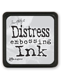 A Tim Holtz Distress Embossing Ink pad by Ranger, featuring a textured light gray surface with black text and a black border.