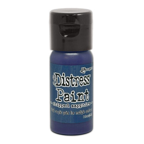 Blue bottle of Ranger Distress Paint with black cap on a white background