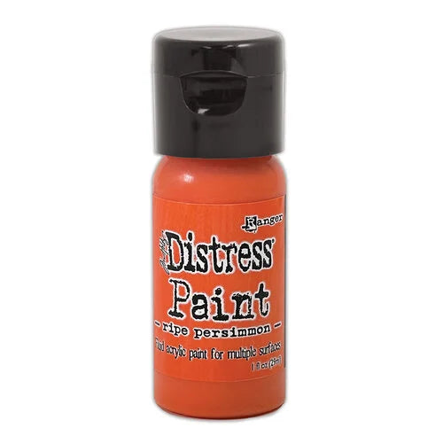 Orange bottle of Ranger Distress Paint with black cap on a white background