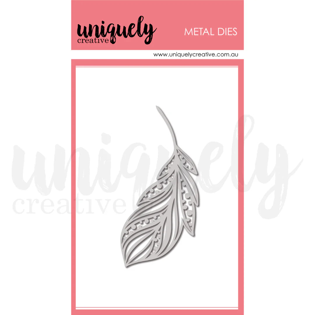 Metal die cut in the shape of a feather with 'uniquely creative' branding on a pink and white background.