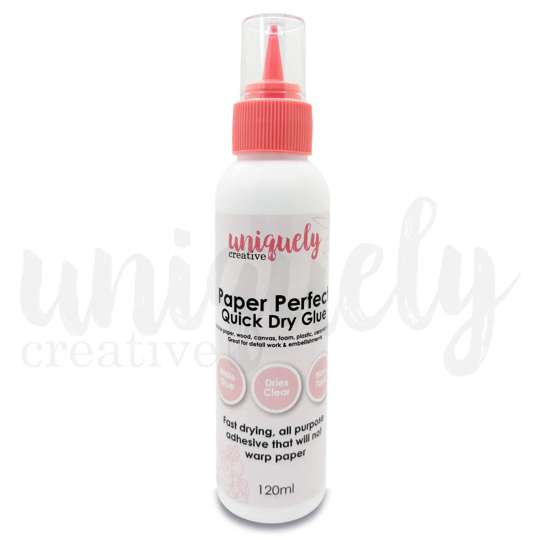 Bottle of uniquely creative Paper Perfect Quick Dry Glue on a white background