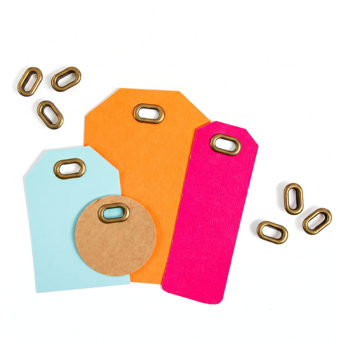 Copper oval eyelets used on colourful cardstock tags for paper crafting